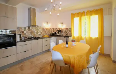 a kitchen with a yellow table and white chairs at Amazing Home In Lagnes in Lagnes