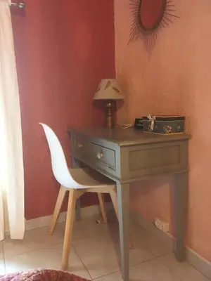 a desk with a chair and a lamp on it at Tramontane chambre salon et piscine in Jonquerettes