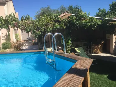 a swimming pool with a slide in a yard at Tramontane chambre salon et piscine in Jonquerettes