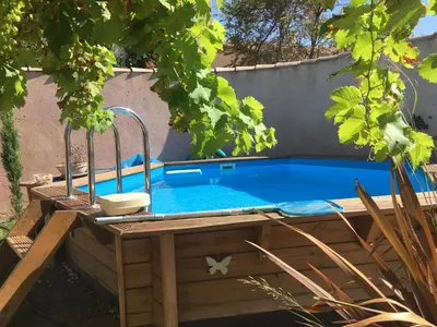 a swimming pool in a yard with afficientfficientfficientfficientfficientfficient at Tramontane chambre salon et piscine in Jonquerettes
