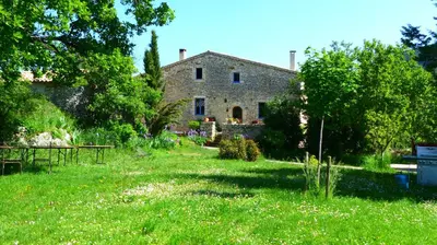 an old stone house in the middle of a field at Chambre d'hôte dans ferme provençale in Banon