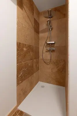 a shower with a shower head in a bathroom at La Cayon Au coeur des oliviers en Provence in Pélissanne