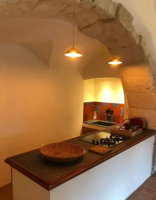 a kitchen with a counter with a sink and a stove at studio au coeur de Lacoste in Lacoste