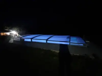 a person standing in the dark with a blue light at 4 bedroom villa pool entire place in Salon-de-Provence