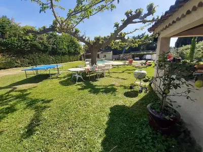 a yard with a ping pong table and a tree at 4 bedroom villa pool entire place in Salon-de-Provence