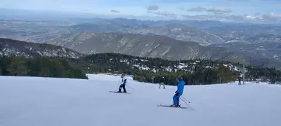 a group of people skiing on a snow covered slope at Le Portail Vert in Villes-sur-Auzon