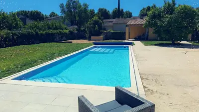 a swimming pool in the backyard of a house at Le Portail Vert in Villes-sur-Auzon