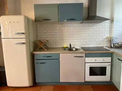 a kitchen with a white refrigerator and a sink at Maison cosy en Provence Proche Golf Pont Royal in Alleins