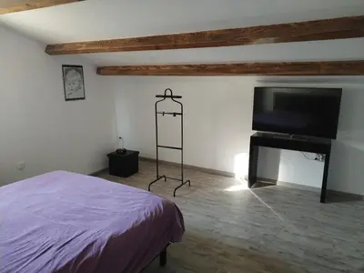 a bedroom with a bed and a flat screen tv at Close to Saint-Rémy-de-Provence in Eyragues
