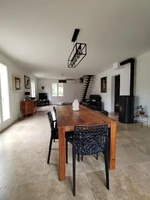 a dining room with a wooden table and chairs at Close to Saint-Rémy-de-Provence in Eyragues