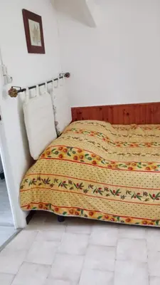a bed sitting in a bedroom with a bedspread at Aix en Provence in Aix-en-Provence