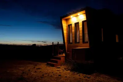 a tiny house lit up at night at La Tiny House des Vignes du Château de Vauclaire in Meyrargues