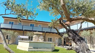 a building with a statue in front of it at Mas d'Andiol in Plan-dʼOrgon