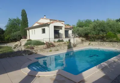 a swimming pool in front of a house at Sous le figuier in La Roque-sur-Pernes