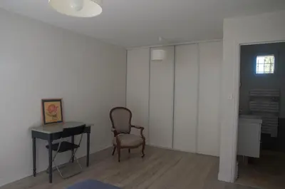a room with a desk and a chair and a table at Sous le figuier in La Roque-sur-Pernes