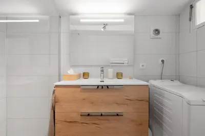 a white bathroom with a sink and a mirror at Le Chastel, T3, Aix Centre Ville in Aix-en-Provence
