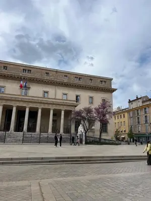 a large building with people walking in front of it at Le Chastel, T3, Aix Centre Ville in Aix-en-Provence