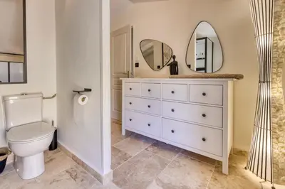 a bathroom with a white toilet and a mirror at VILLA Isle sur la Sorgue in LʼIsle-sur-la-Sorgue