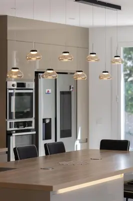 a kitchen with a large wooden table with chairs at La Villa L'Isle-St-Antoine piscine chauffée in LʼIsle-sur-la-Sorgue