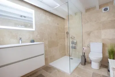 a bathroom with a toilet and a glass shower at La Villa L'Isle-St-Antoine piscine chauffée in LʼIsle-sur-la-Sorgue