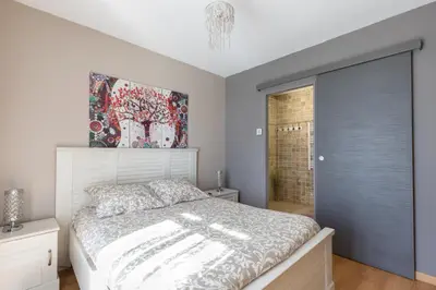a bedroom with a white bed and a window at La Villa L'Isle-St-Antoine piscine chauffée in LʼIsle-sur-la-Sorgue