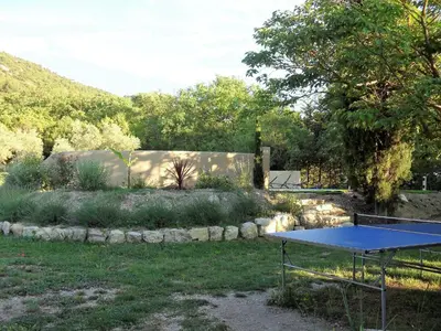 a ping pong table in the middle of a yard at Bastide De La Lézardière in Fontaine-de-Vaucluse