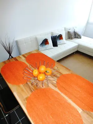 a living room with a wooden table with a sculpture of a sun at Bastide De La Lézardière in Fontaine-de-Vaucluse