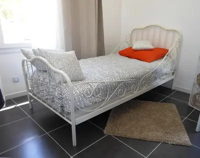 a white bed in a room with a window at Bastide De La Lézardière in Fontaine-de-Vaucluse