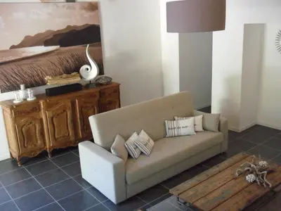 a living room with a couch and a bed at Bastide De La Lézardière in Fontaine-de-Vaucluse