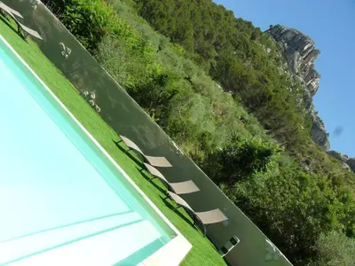 an overhead view of a road next to a mountain at Bastide De La Lézardière in Fontaine-de-Vaucluse