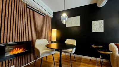 a dining room with a table and a fireplace at Suite dans le centre historique in Aix-en-Provence
