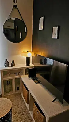 a living room with a table and a mirror at Suite dans le centre historique in Aix-en-Provence