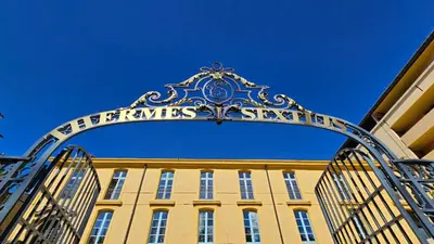 an entrance to a yellow building with a gate at Suite dans le centre historique in Aix-en-Provence
