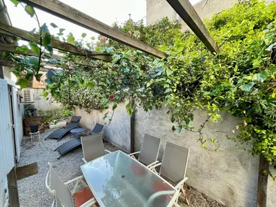 a patio with chairs and a table and plants at Chaleureux Appartement RDC 49 m2 avec Jardin in Aix-en-Provence
