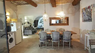 a kitchen and dining room with a table and chairs at Le LOFT LOURMARIN in Lourmarin