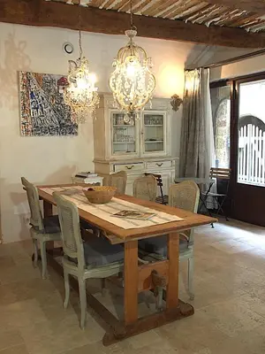 a dining room with a wooden table and chairs at Le LOFT LOURMARIN in Lourmarin