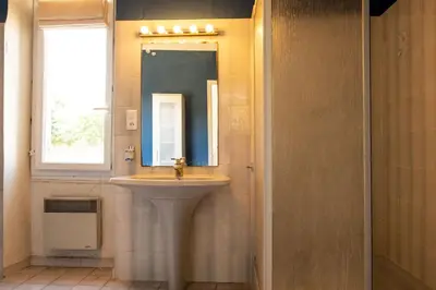 a bathroom with a sink and a mirror at La maison du bonheur in Pélissanne