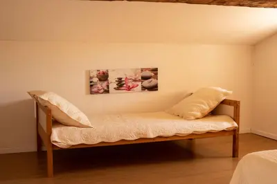 a bench in a room with a painting on the wall at La maison du bonheur in Pélissanne