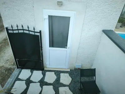 a door in the side of a building with a tile floor at Logement 2 personnes in Morières-lès-Avignon