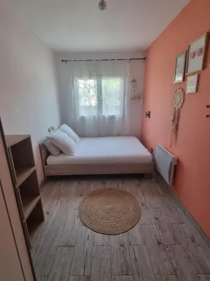 a small bedroom with a bed and a window at Maison du Luberon in Maubec
