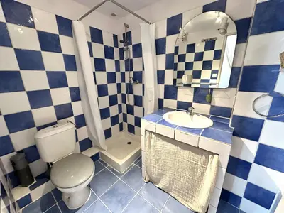 a blue and white bathroom with a toilet and a sink at Historic Centre Location Charming House with Style in Carpentras