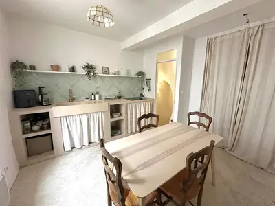 a dining room with a table and a kitchen at Historic Centre Location Charming House with Style in Carpentras