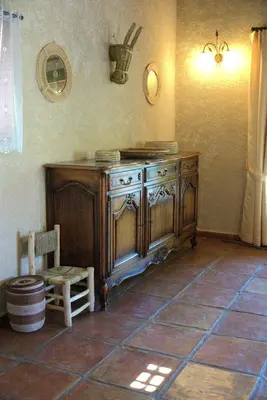 a kitchen with a wooden cabinet and a chair at Villa provençale 4 chambres à Aix en Provence in Aix-en-Provence