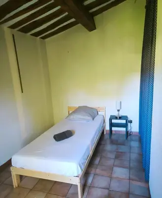 a bedroom with a bed in a room with a table at Villa provençale 4 chambres à Aix en Provence in Aix-en-Provence