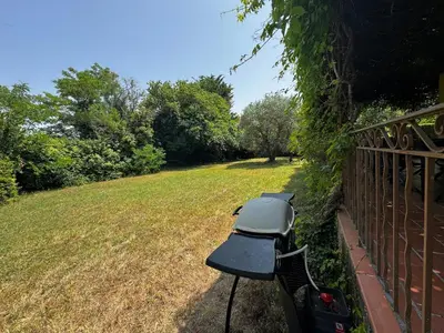 a grill sitting on the side of a fence at La Provençale - Piscine - Chambres climatisées in Aubignan