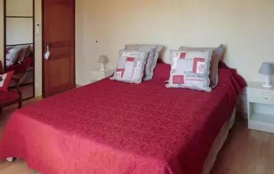 a bedroom with a large red bed with pillows at Amazing Home In Vedène in Vedène