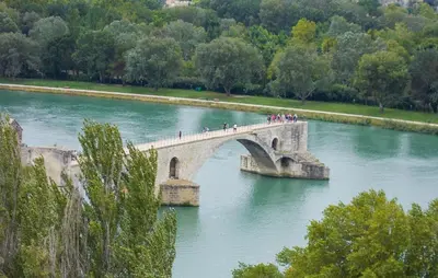 a group of people crossing a bridge over a river at Amazing Home In Vedène in Vedène