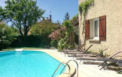 a swimming pool with chairs next to a building at Amazing Home In Vedène in Vedène