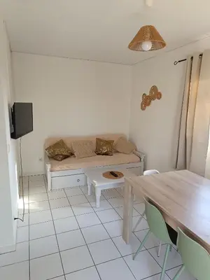 a living room with a couch and a table at La Cigale d'Avignon in Saint-Saturnin-lès-Avignon