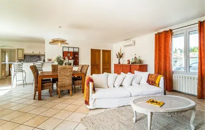 a living room with a white couch and a table at 2 Bedroom Amazing Home In Noves in Noves